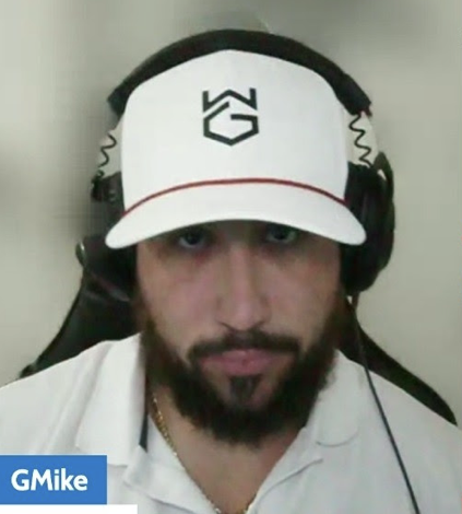 GMike on camera wearing a GMIKEMEDIA cap and headset