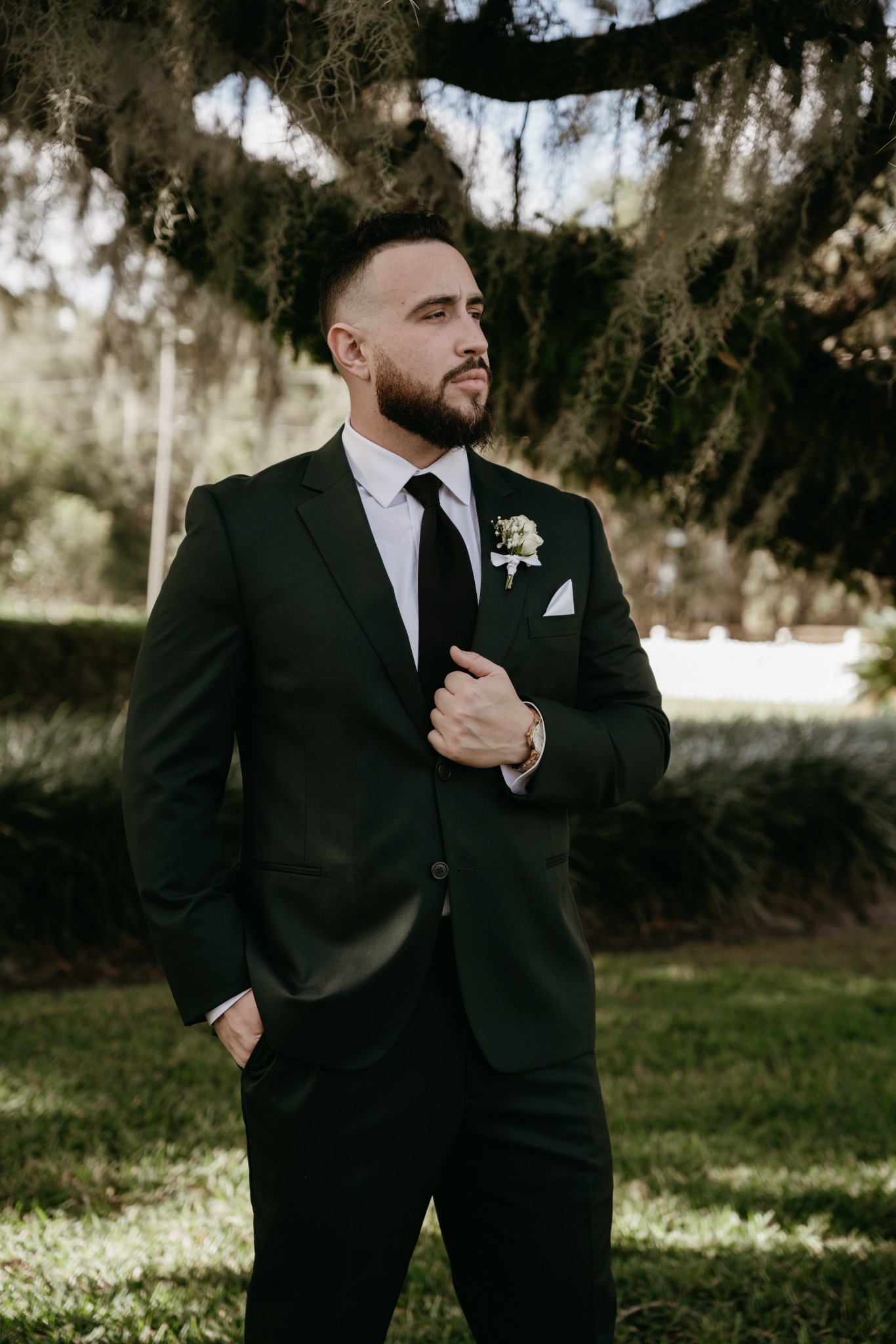 GMike in a black suit outdoors